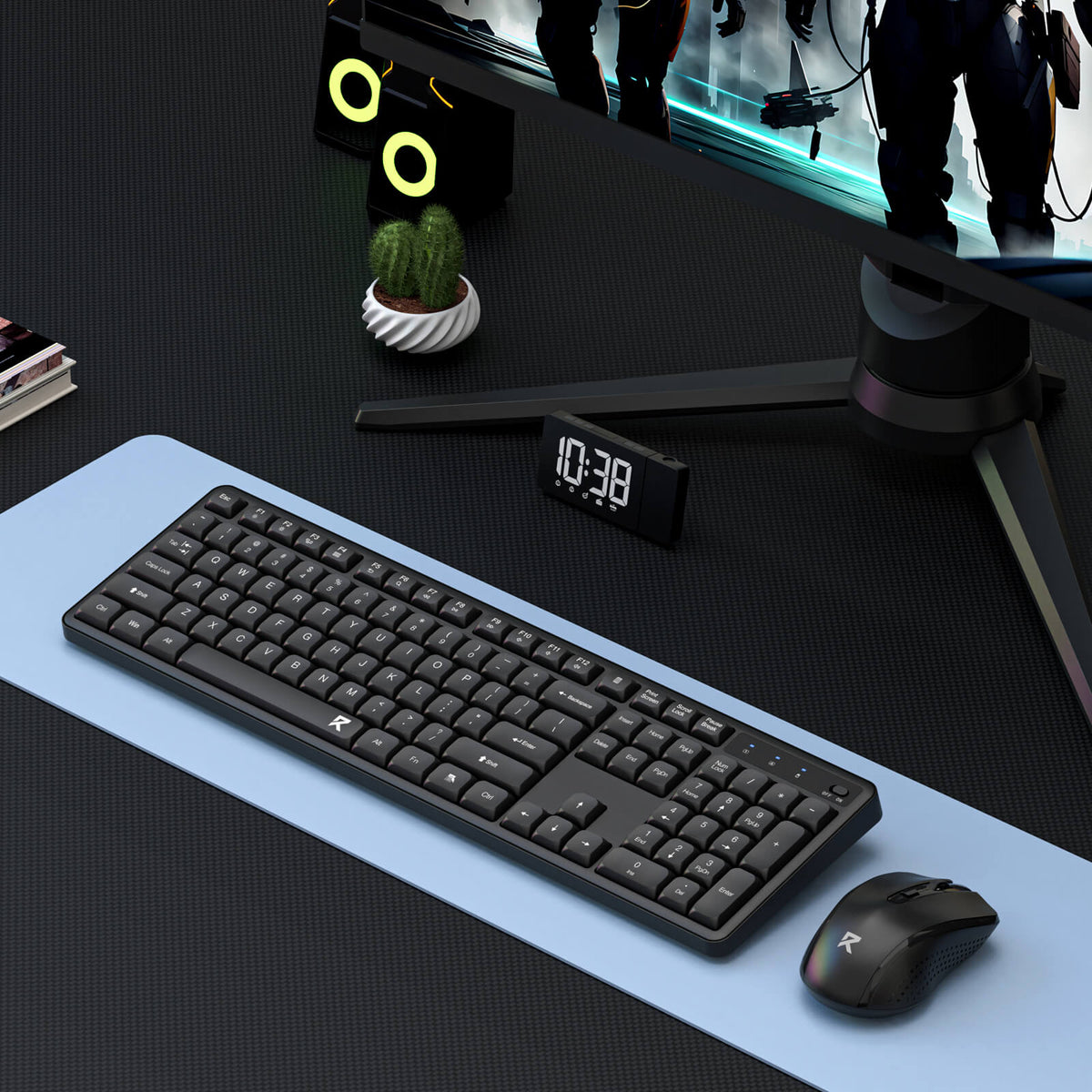 A wireless keyboard and mouse set is displayed in a gaming setup, paired with a monitor, desk clock, and headphones on a light blue desk mat.