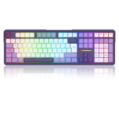 A full-sized mechanical keyboard with a dark frame and RGB backlighting that transitions through a rainbow spectrum of colors across the keys, shown on a reflective white surface.