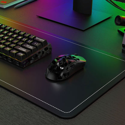 Gaming mouse and keyboard on a large mouse pad with RGB lighting