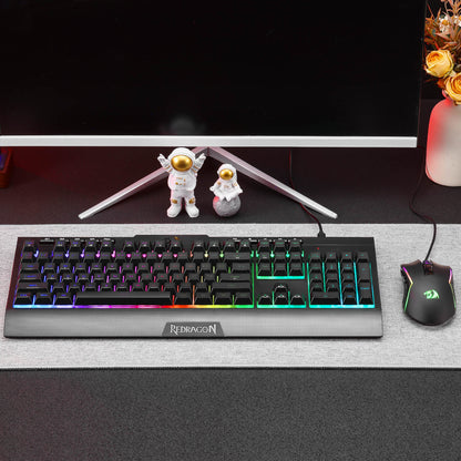 Redragon EU S151 Gaming keyboard with RGB lighting on a desk with a mouse and decor items.