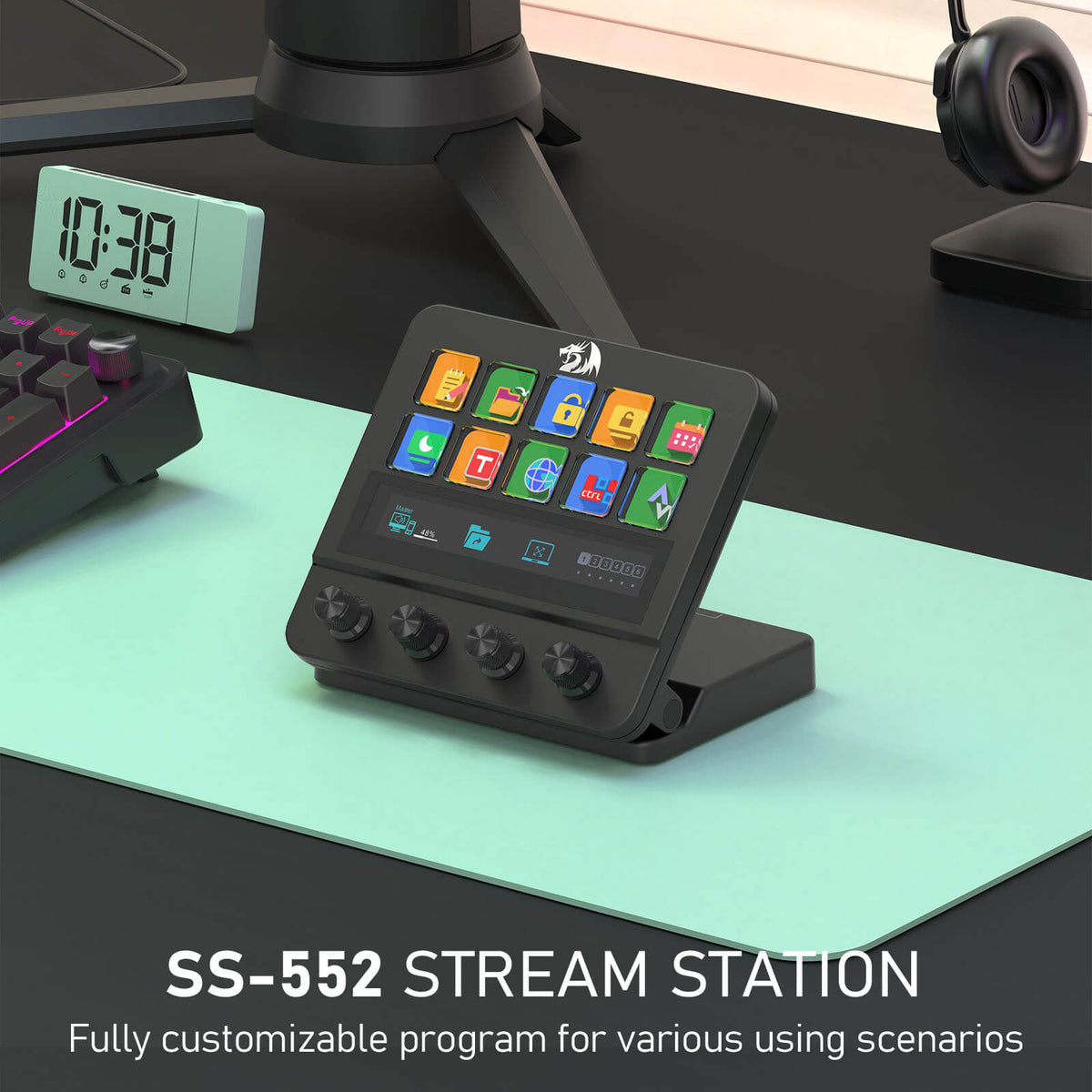Redragon EU SS-552 Stream Station on a desk with a digital clock and headphones in the background